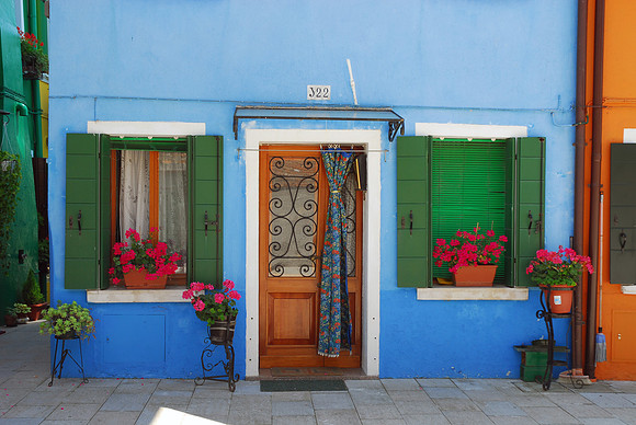 Swirls with Green Shutters & Red Geraniums